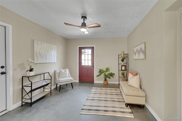 1596 S Stuart St, Denver, CO 80219 - foyer featuring concrete floors and ceiling fan