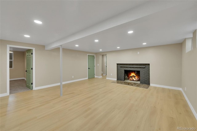 1596 S Stuart St, Denver, CO 80219 - unfurnished living room with a fireplace, light wood-style flooring, and recessed lighting