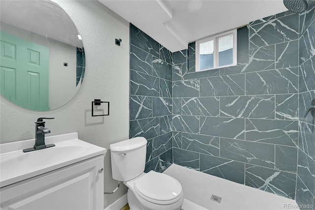 1596 S Stuart St, Denver, CO 80219 - bathroom with a tile shower, vanity, and a textured wall
