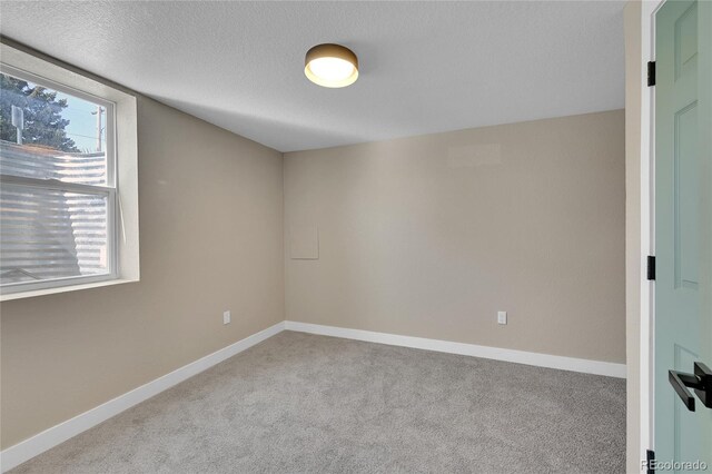 1596 S Stuart St, Denver, CO 80219 - empty room with carpet floors and a textured ceiling