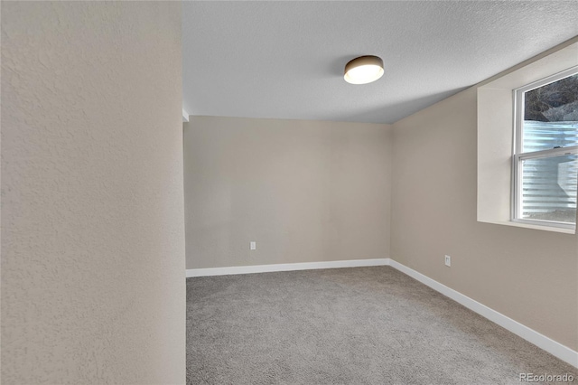 1596 S Stuart St, Denver, CO 80219 - carpeted empty room with baseboards and a textured ceiling