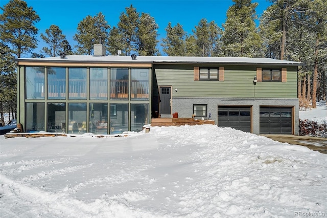 view of front of home with a garage and a chimney