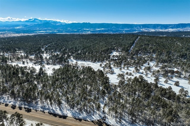 snowy aerial view featuring a mountain view