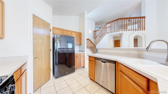 2314 Flagstaff Dr, Longmont, CO 80504 - kitchen featuring freestanding refrigerator, stainless steel dishwasher, light tile patterned flooring, a sink, and light countertops