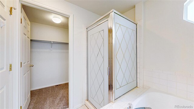 2314 Flagstaff Dr, Longmont, CO 80504 - bathroom featuring a stall shower, a spacious closet, and a garden tub