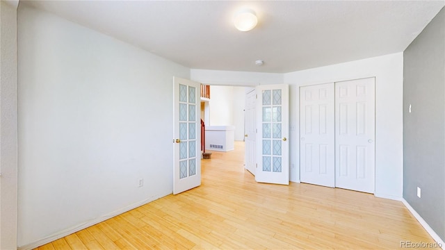 2314 Flagstaff Dr, Longmont, CO 80504 - unfurnished bedroom featuring french doors, wood finished floors, baseboards, and a closet