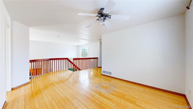 2314 Flagstaff Dr, Longmont, CO 80504 - empty room with ceiling fan, hardwood / wood-style flooring, and baseboards