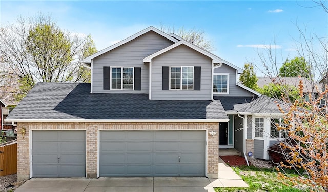 2314 Flagstaff Dr, Longmont, CO 80504 - view of front of property featuring a shingled roof, driveway, and fence