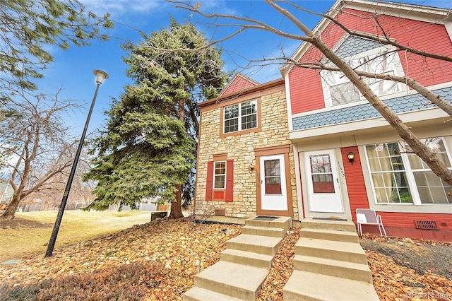 view of property featuring stone siding and crawl space