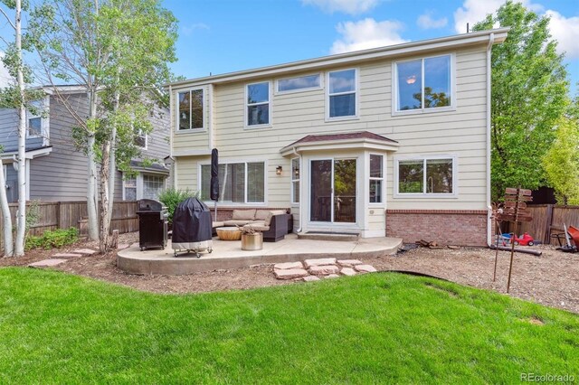 1441 Cherry Pl, Erie, CO 80516 - rear view of property featuring a patio area, brick siding, and an outdoor living space