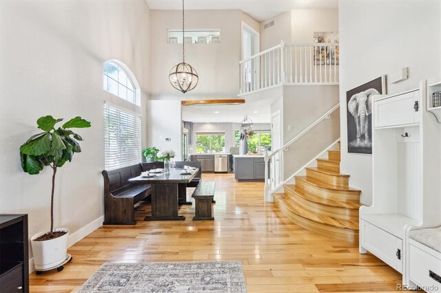 1441 Cherry Pl, Erie, CO 80516 - entryway featuring stairs, a chandelier, light wood-style floors, and a towering ceiling