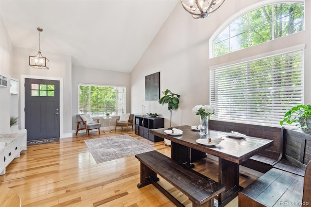 1441 Cherry Pl, Erie, CO 80516 - dining room with a chandelier, high vaulted ceiling, and light wood-style floors