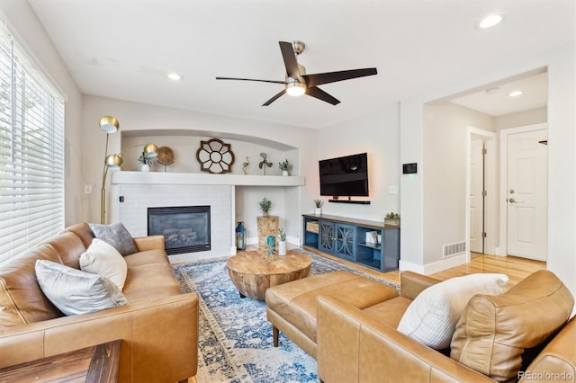 1441 Cherry Pl, Erie, CO 80516 - living area with a ceiling fan, a glass covered fireplace, recessed lighting, wood finished floors, and built in features
