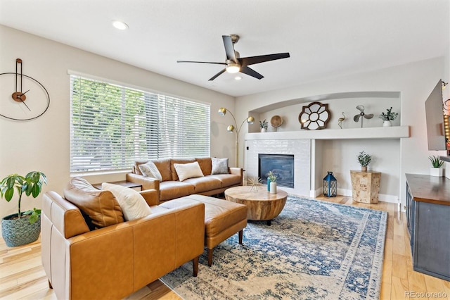 1441 Cherry Pl, Erie, CO 80516 - living area featuring a ceiling fan, light wood-style flooring, a glass covered fireplace, and recessed lighting