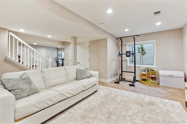 1441 Cherry Pl, Erie, CO 80516 - living area featuring wood finished floors, recessed lighting, plenty of natural light, and stairway