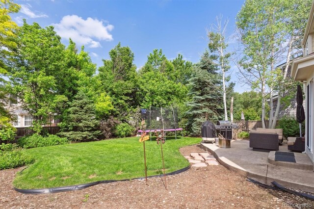 1441 Cherry Pl, Erie, CO 80516 - view of yard with a trampoline, a patio, and outdoor lounge area