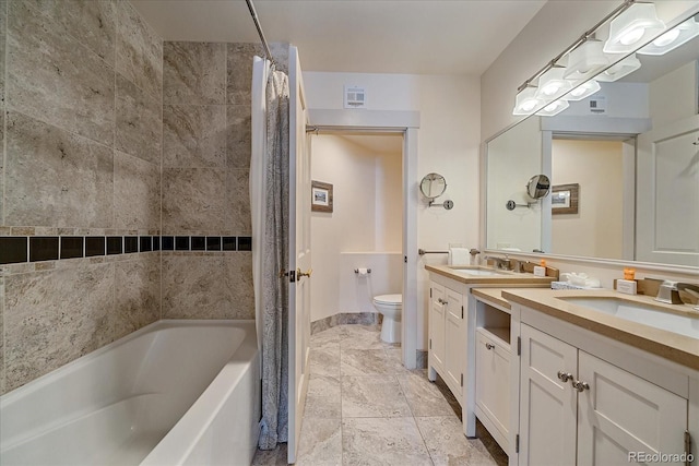 full bathroom featuring toilet, vanity, and shower / bath combo with shower curtain