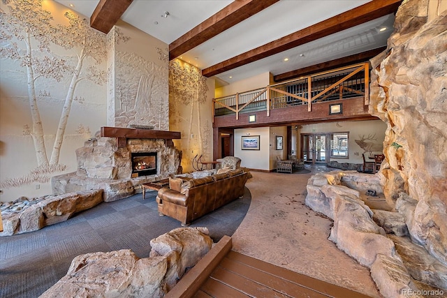 living room with carpet floors, a fireplace, a high ceiling, and beamed ceiling