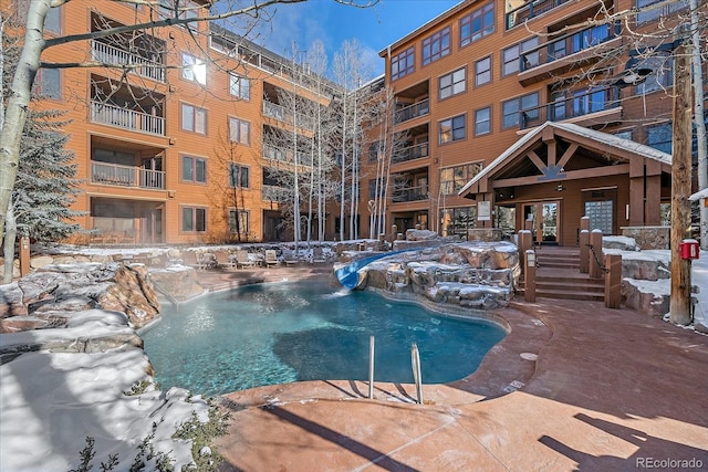 snow covered pool featuring pool water feature