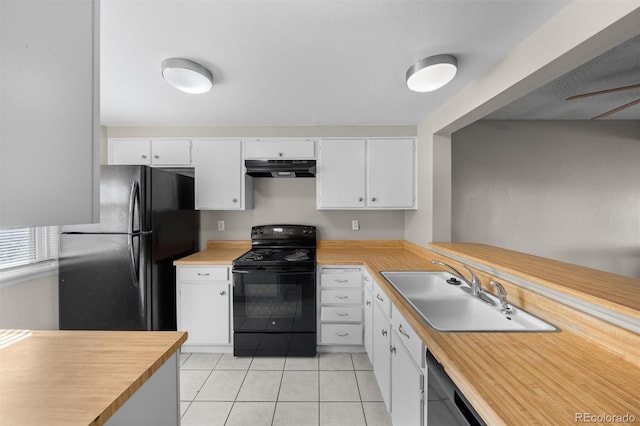 kitchen featuring light tile patterned floors, white cabinets, sink, and black appliances