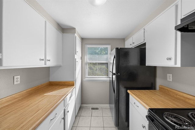 kitchen featuring light tile patterned flooring, white cabinets, black appliances, and exhaust hood