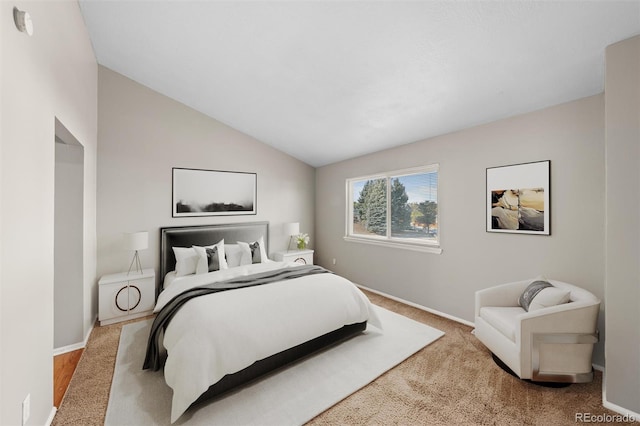 carpeted bedroom with lofted ceiling