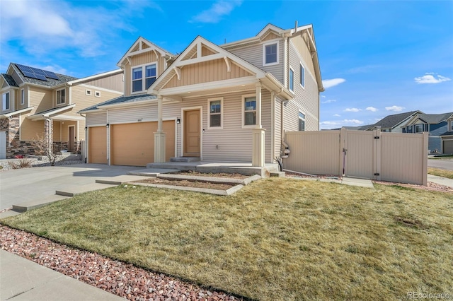 craftsman inspired home with board and batten siding, a front yard, a gate, an attached garage, and driveway