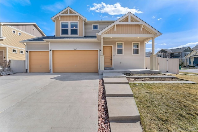 craftsman house featuring board and batten siding, a garage, fence, a gate, and concrete driveway