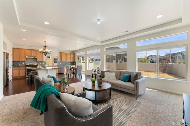 living area featuring baseboards, a chandelier, recessed lighting, visible vents, and dark wood finished floors