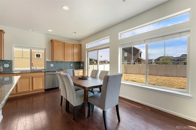 dining area with dark wood-type flooring, baseboards, and recessed lighting