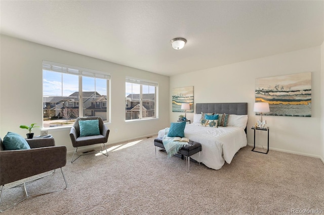 carpeted bedroom featuring baseboards