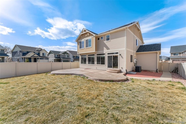 rear view of property with a patio area, a fenced backyard, and a yard