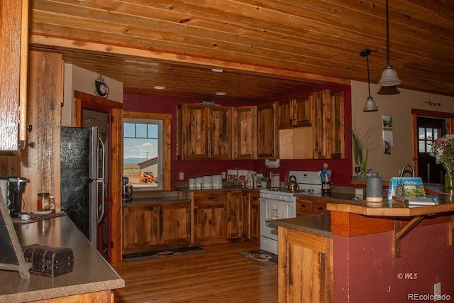 kitchen with white range with gas stovetop, fridge, pendant lighting, wood-type flooring, and wooden ceiling