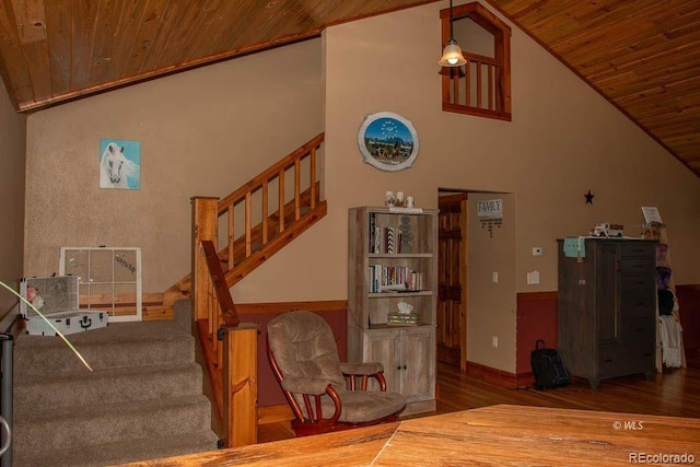 stairs with wooden ceiling, high vaulted ceiling, and wood-type flooring