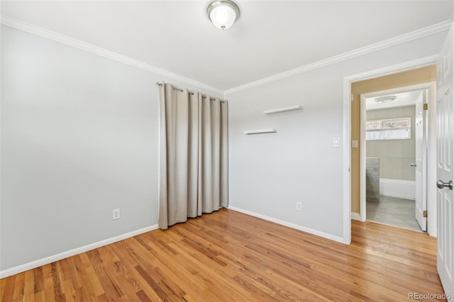 unfurnished bedroom featuring light wood-style flooring, crown molding, and baseboards