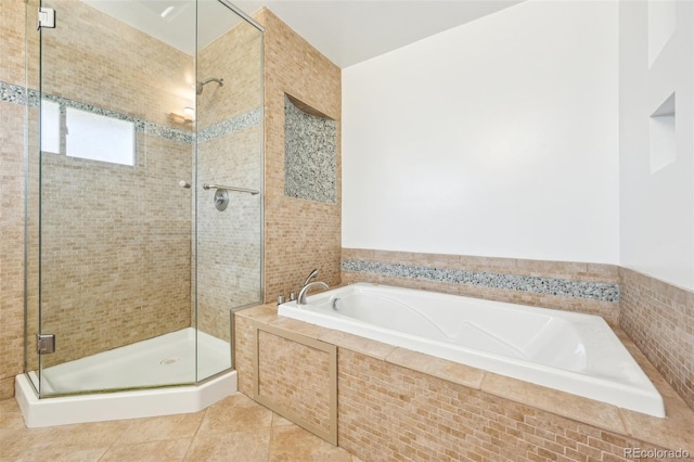 full bath with tile patterned floors, a stall shower, and a garden tub