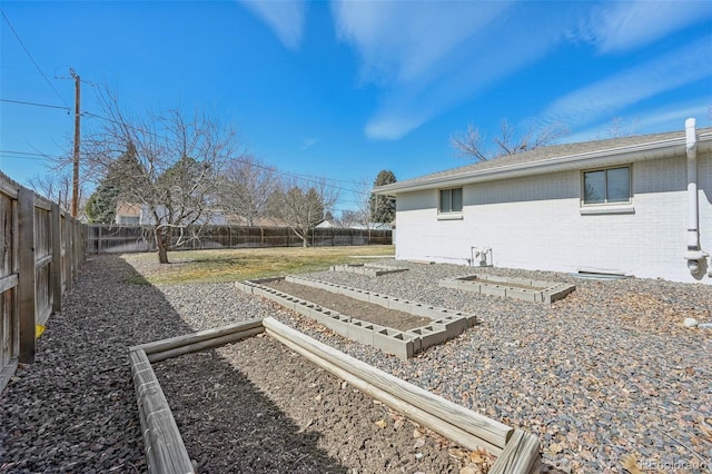 view of yard with a fenced backyard and a garden