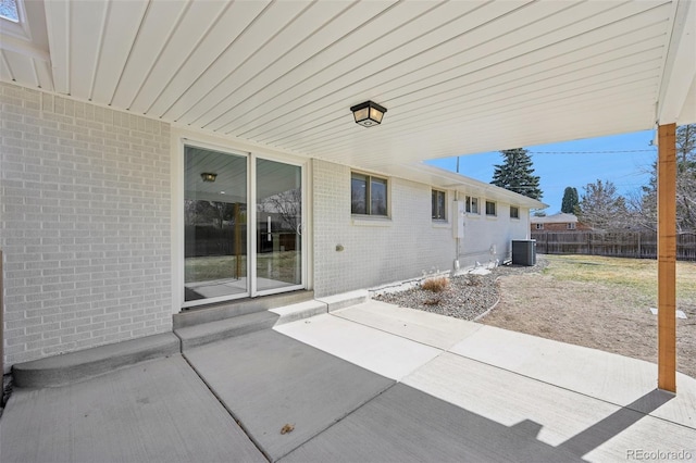 view of patio featuring central air condition unit and fence