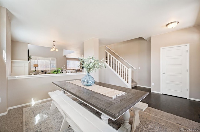 dining area featuring stairway, an inviting chandelier, baseboards, and wood finished floors