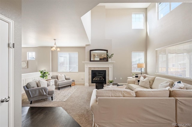 living room with a tiled fireplace and wood finished floors