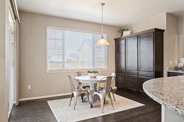 dining area featuring visible vents, baseboards, and dark wood-style flooring