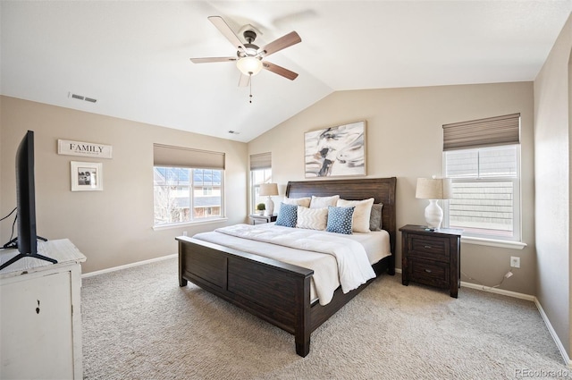 carpeted bedroom with visible vents, lofted ceiling, baseboards, and a ceiling fan