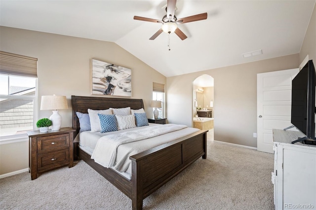 bedroom with visible vents, light carpet, lofted ceiling, arched walkways, and baseboards