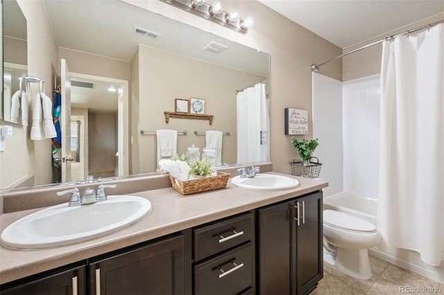 bathroom featuring shower / tub combo, toilet, visible vents, and a sink