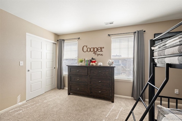 carpeted bedroom with baseboards and visible vents