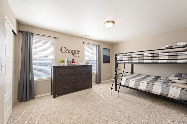 bedroom with carpet, visible vents, and baseboards