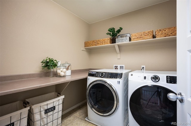 clothes washing area with light tile patterned floors, laundry area, and washing machine and dryer