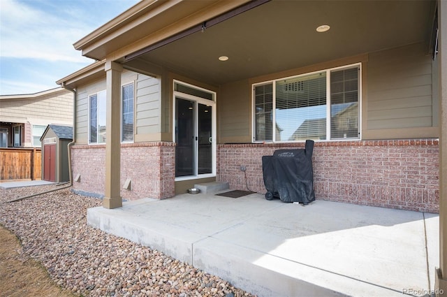 view of patio / terrace featuring an outbuilding and a storage unit