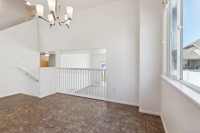719 Elk Mountain Dr, Severance, CO 80550 - unfurnished room featuring a chandelier and baseboards