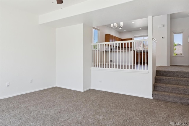 719 Elk Mountain Dr, Severance, CO 80550 - unfurnished room featuring carpet flooring, a chandelier, baseboards, a ceiling fan, and recessed lighting